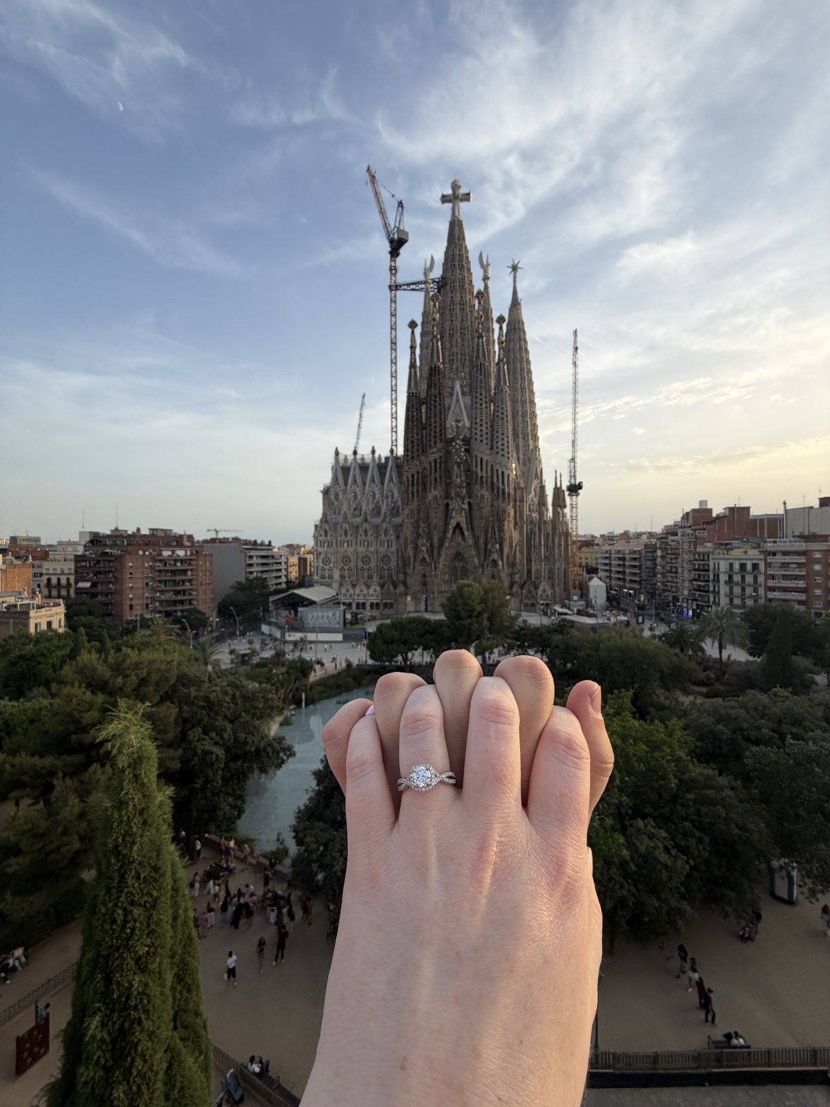 Kaitlyn showing her engagement ring with Sagrada Família behind her