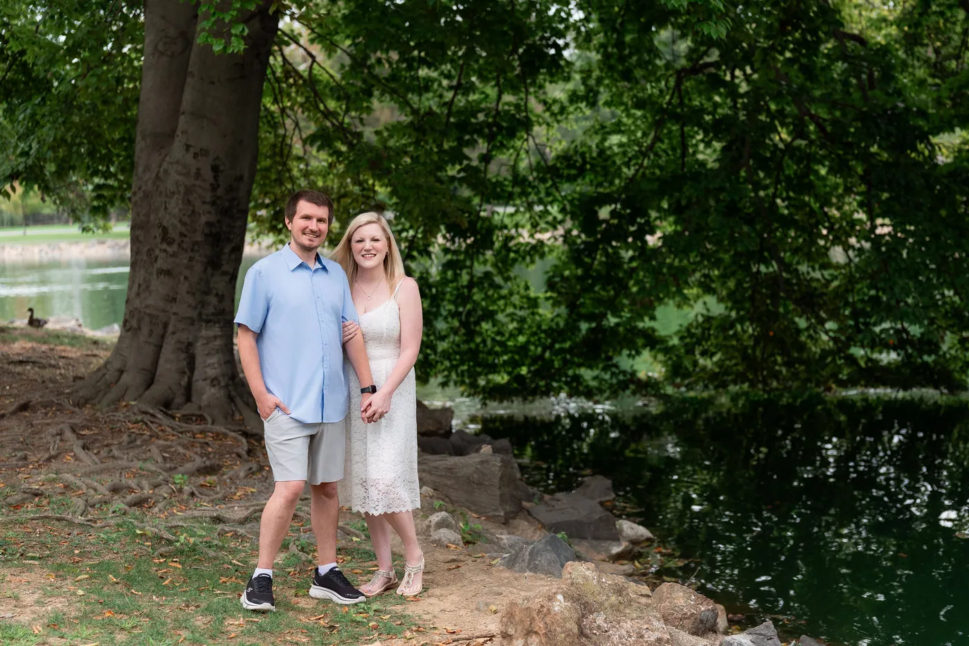 Kaitlyn and Nicholas standing together beneath the trees