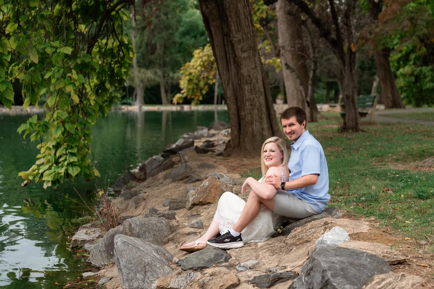 Kaitlyn and Nicholas sitting together beside the pond