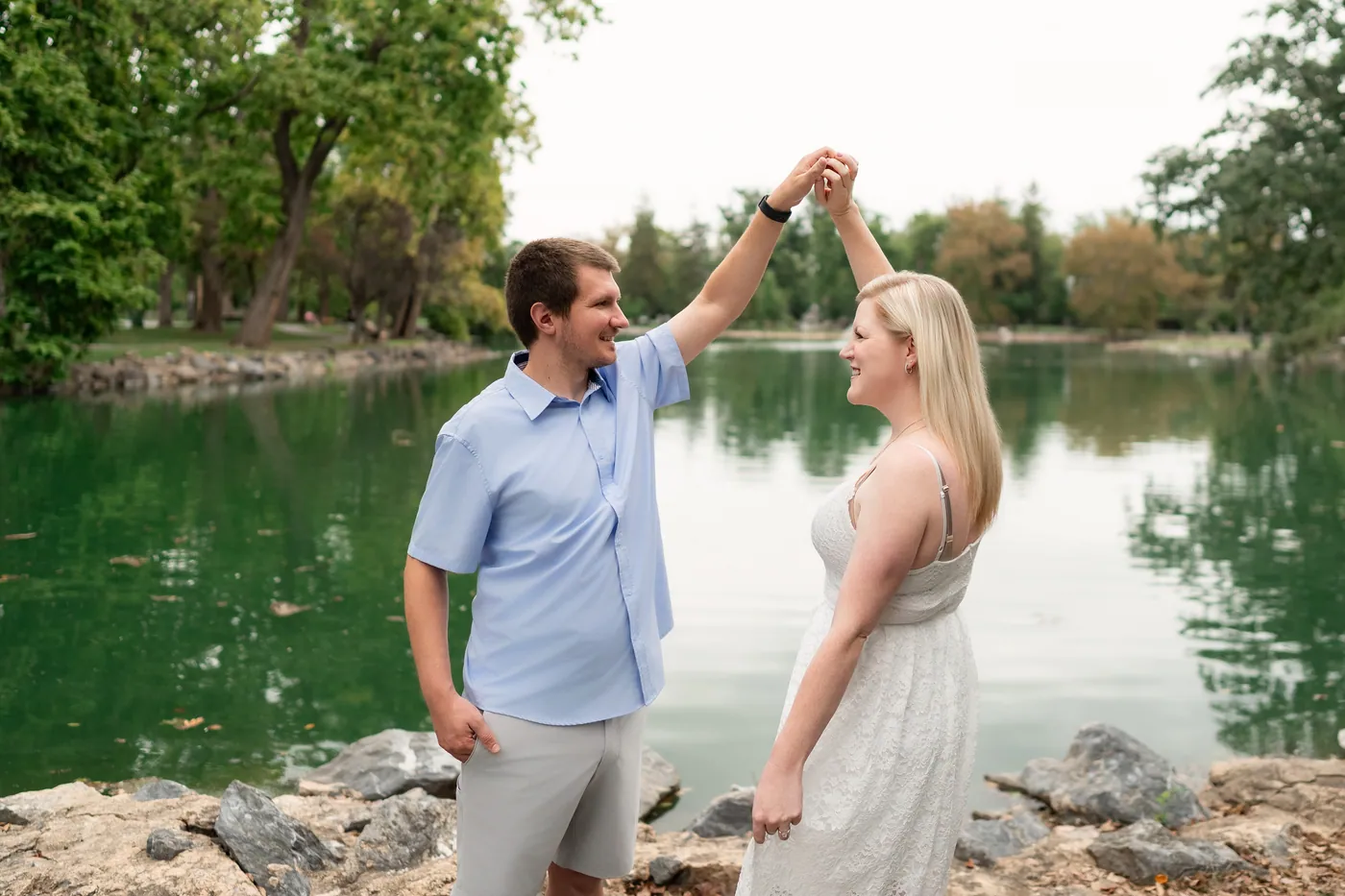 Nicholas twirling Kaitlyn beside the pond