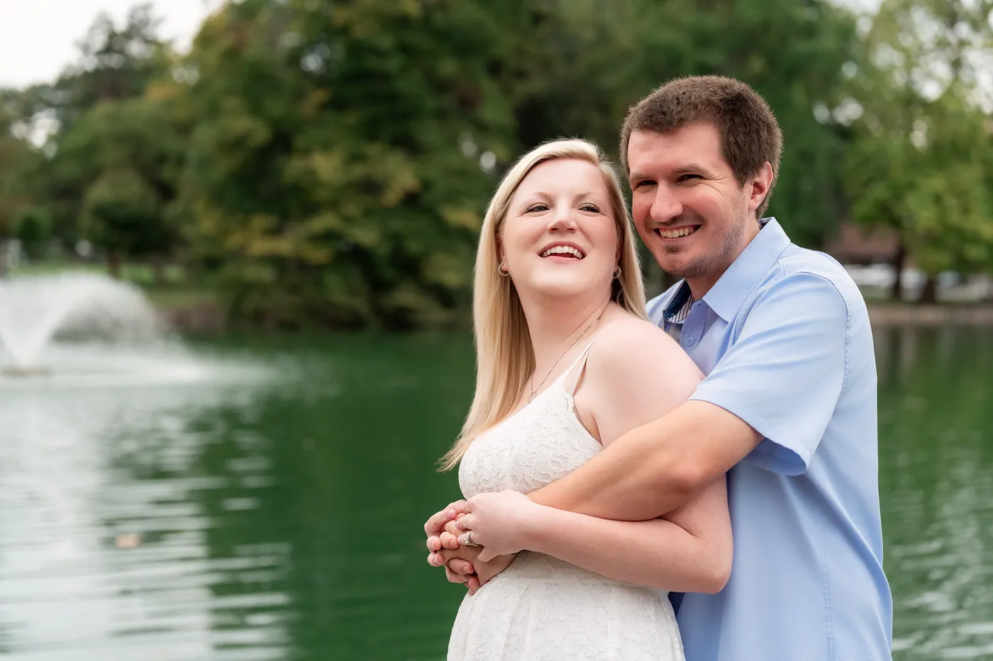 Kaitlyn and Nicholas smiling together with the fountain behind them